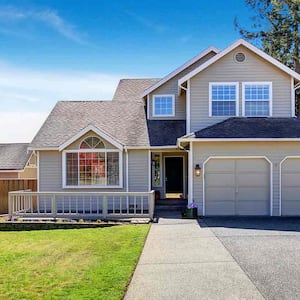 grey suburban home with porch 