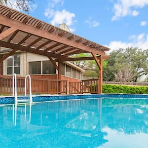 ground pool with a covered wooden deck