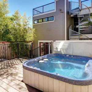 Small wooden walkout deck with hot tub