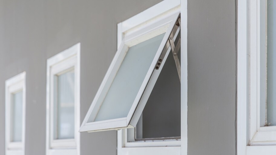 gray house with awning window open