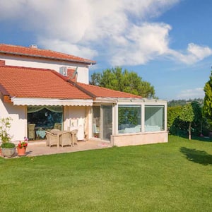 A house backyard with trees and lawn