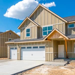 A street of partially finished new homes in a new suburban housing development