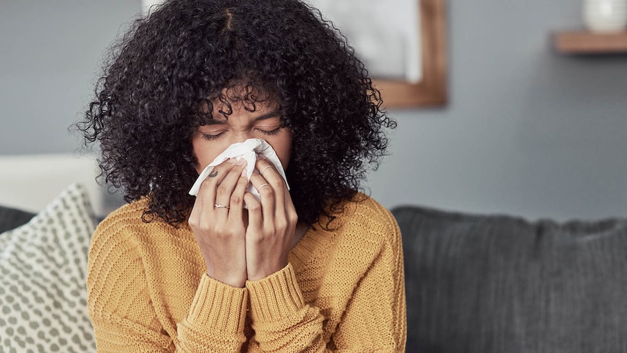 woman blowing her nose