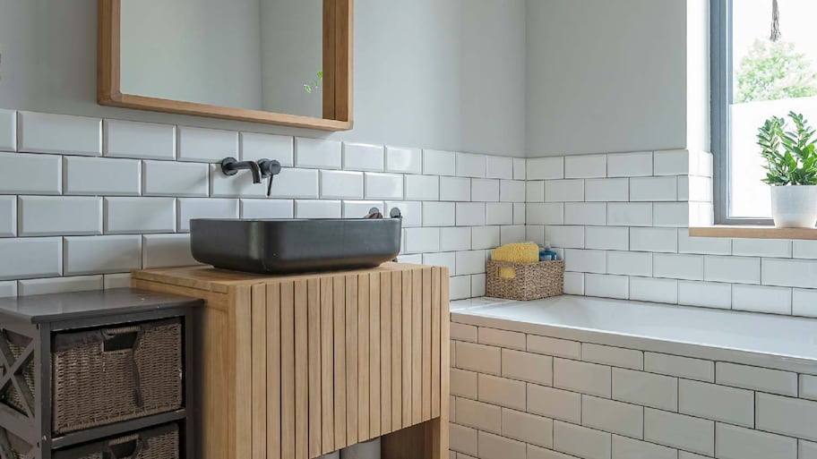 The interior of a bright bathroom with subway tiles