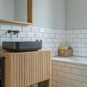 The interior of a bright bathroom with subway tiles