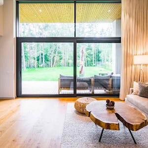 The interior of a living room with views to the backyard