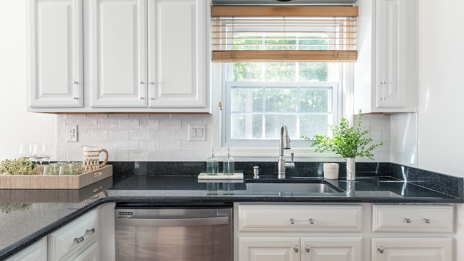 A kitchen with white cabinets