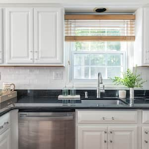 A kitchen with white cabinets