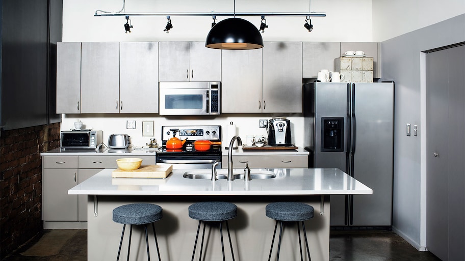 A view of a kitchen with a microwave over the stove