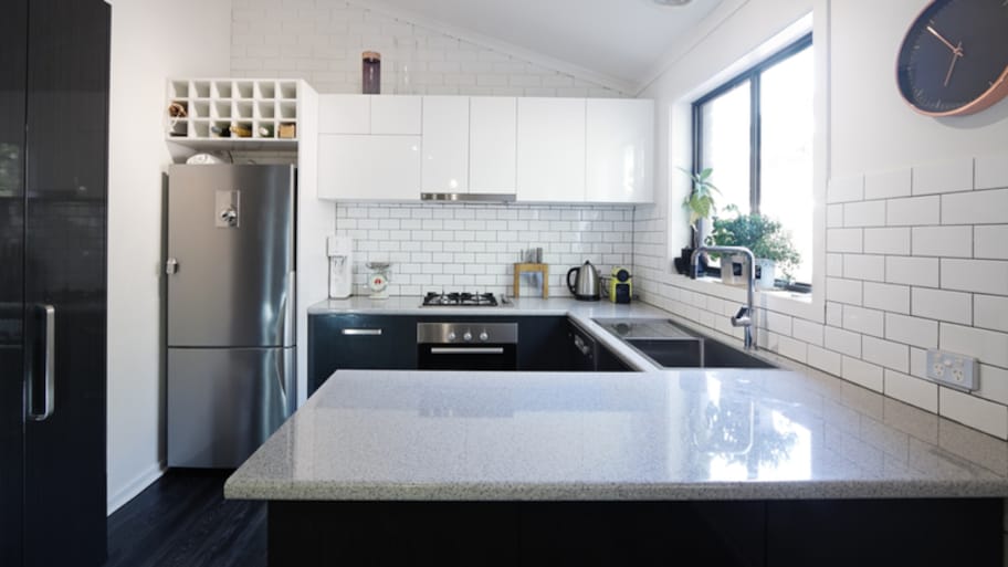 Dark blue L-shaped kitchen island