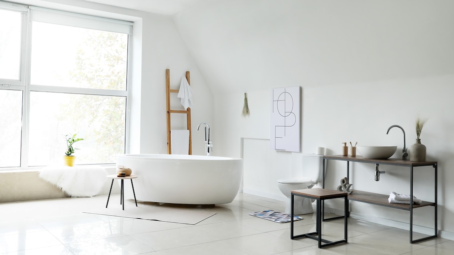  An old ladder used as a towel rack in a bathroom