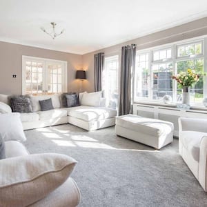 A large and bright carpeted living room 