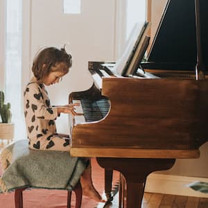 little girl playing piano