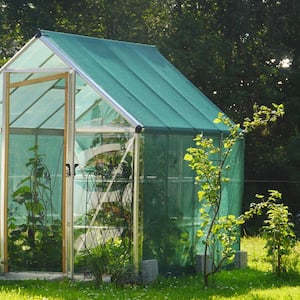 A little greenhouse in a yard of a house