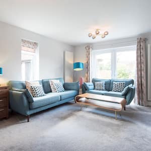 A retro living room with a wall-to-wall carpet