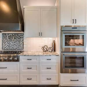 kitchen hood with mosaic tile backsplash