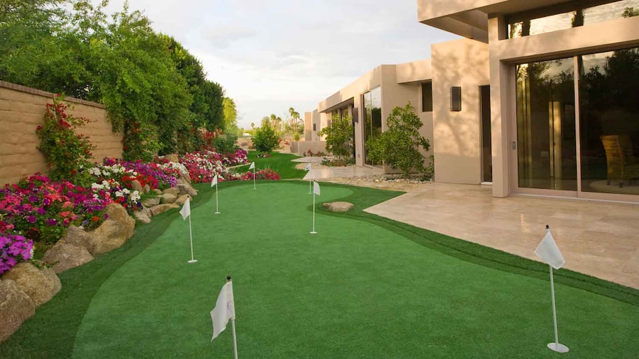 A luxury house with a backyard putting green