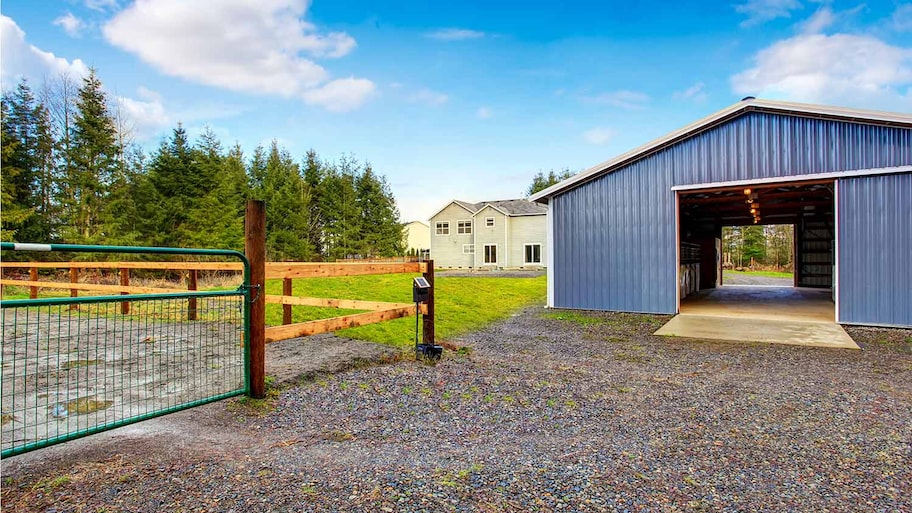 Farm blue barn shed and gravel driveway.