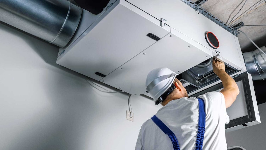 A man cleaning an air duct 