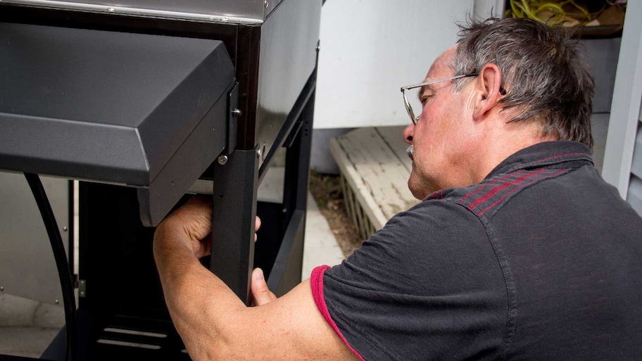 A man connecting a new grill