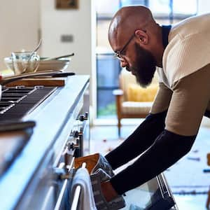 A man cooking on a gas stove