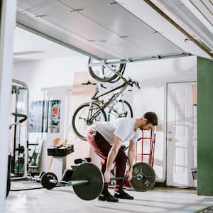 A man exercises in garage turned into home gym