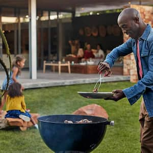 A man grilling in his yard