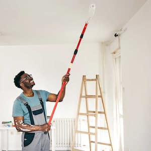 Young man repairing ceiling of the apartment