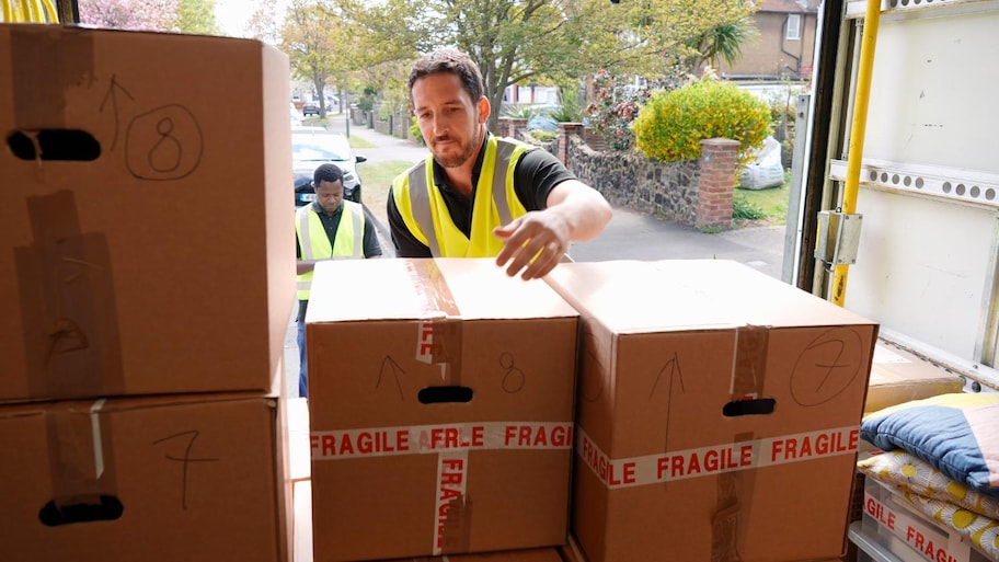 A man unloading boxes from van