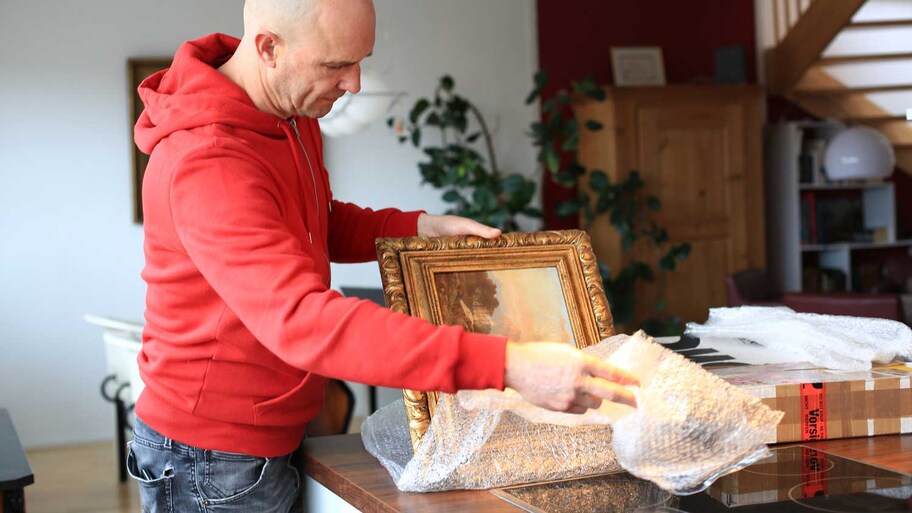 A man wrapping in bubble wrap precious art