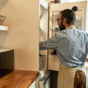 Man opening up refrigerator door