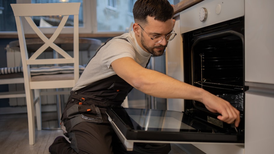 Man adjusting oven door