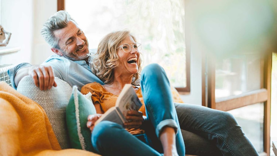 A mature couple relaxing on their sofa 