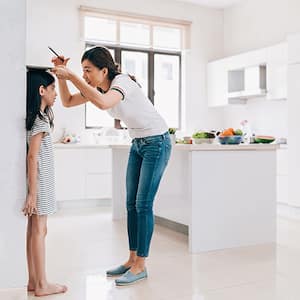 Measuring height of child on a big wall, open concept kitchen 