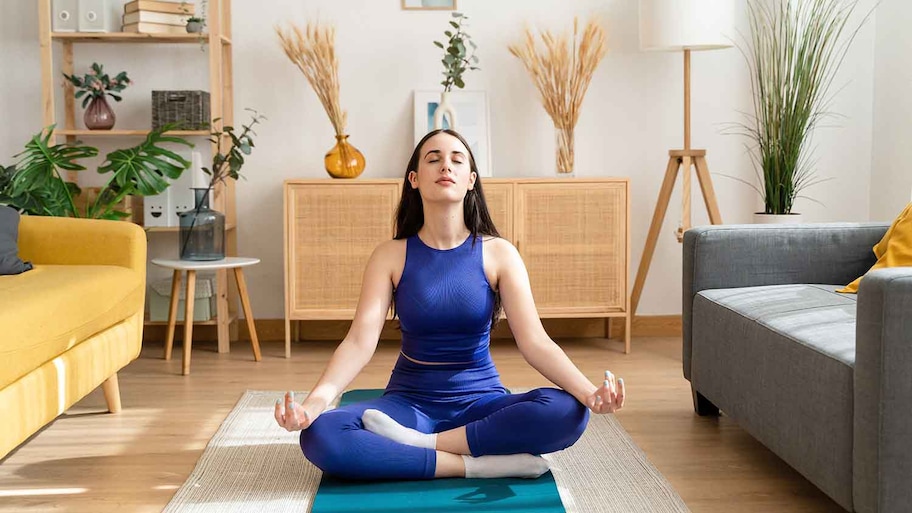 Woman meditating in the living room