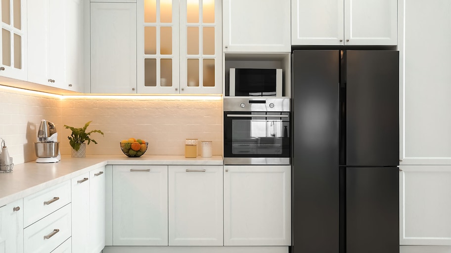 white kitchen decor with sleek black fridge