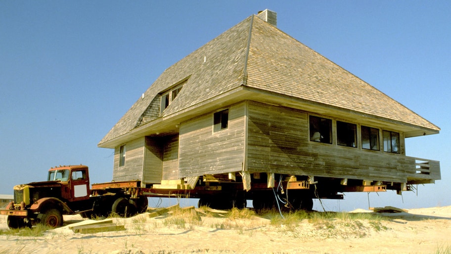 Truck with big wooden house on trailer