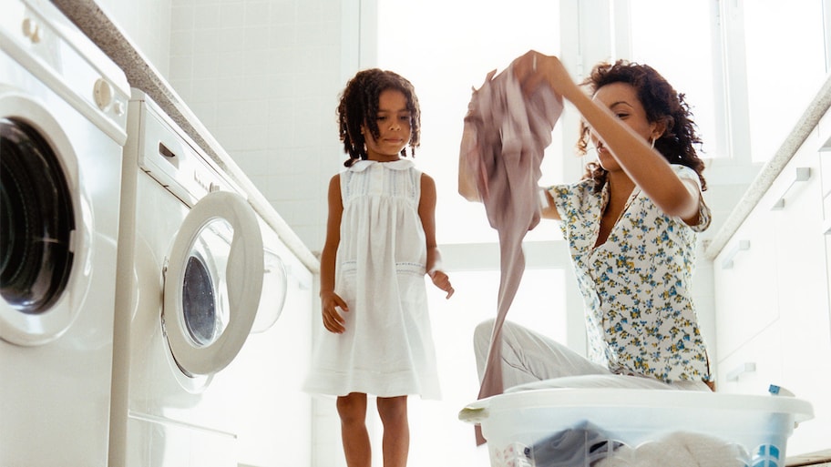 Mother and daughter in laundry room