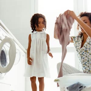 Mother and daughter in laundry room