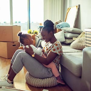 Mother playing with child while packing