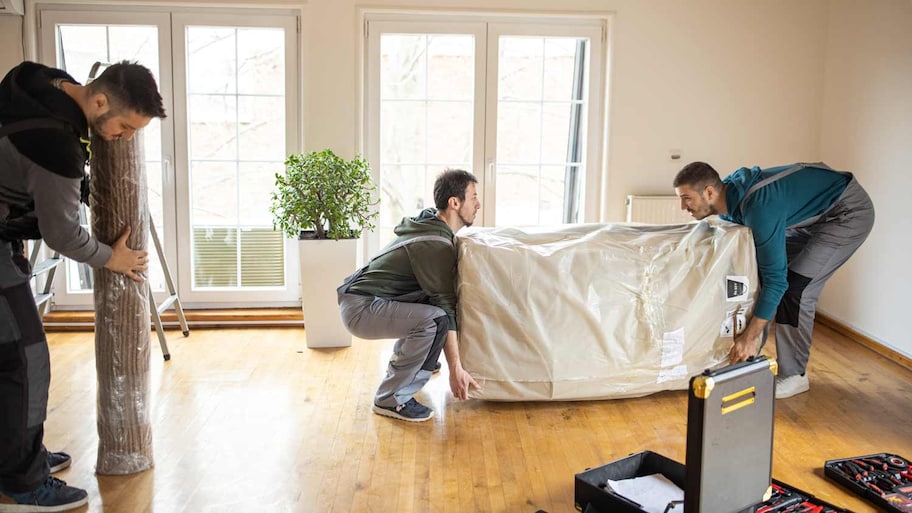 movers carrying furniture into apartment