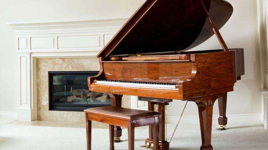 Grand piano in living room with fireplace