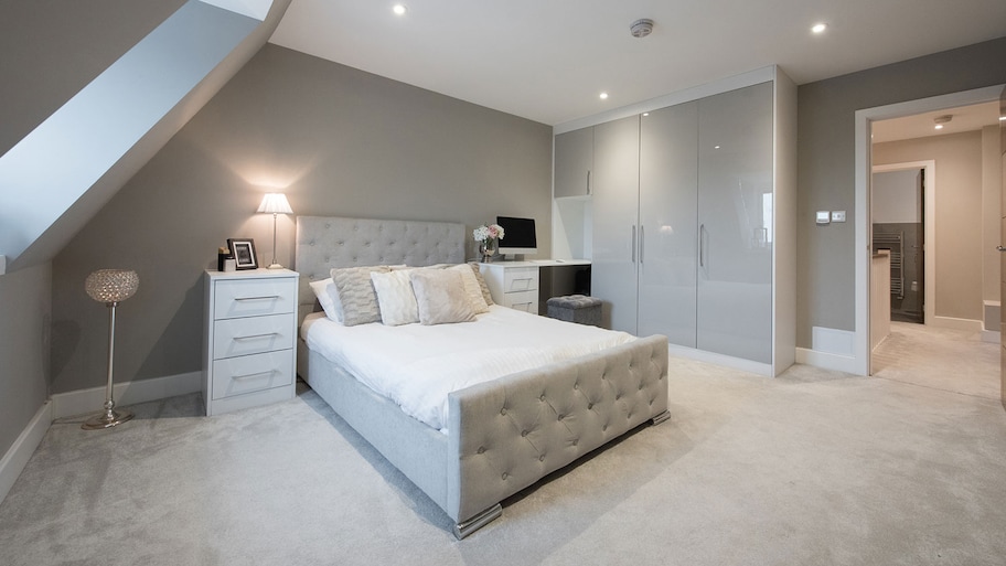 Bedroom with gray carpet and furniture