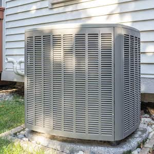 New air conditioner condenser unit outside of a home