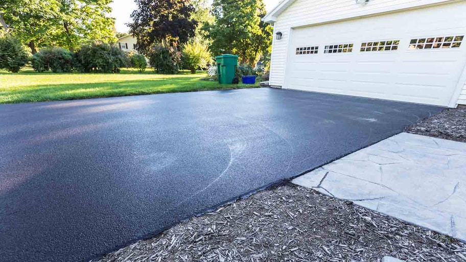 home with new asphalt driveway  