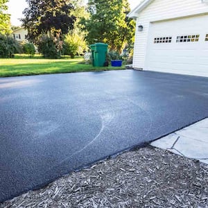 home with new asphalt driveway  
