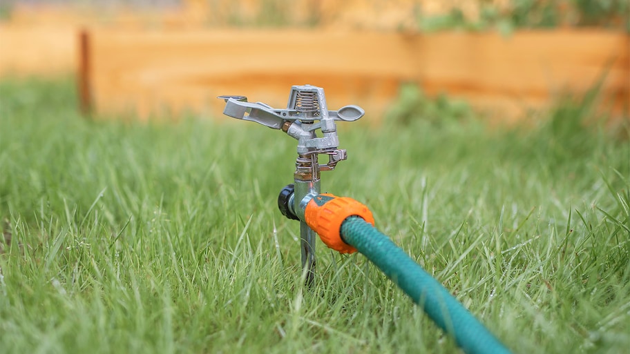 lawn sprinkler in grass turned off