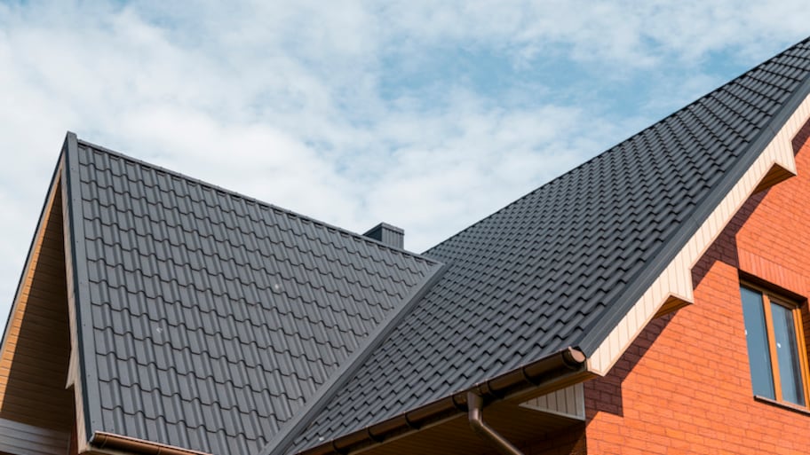 view looking up at black roof of orange house