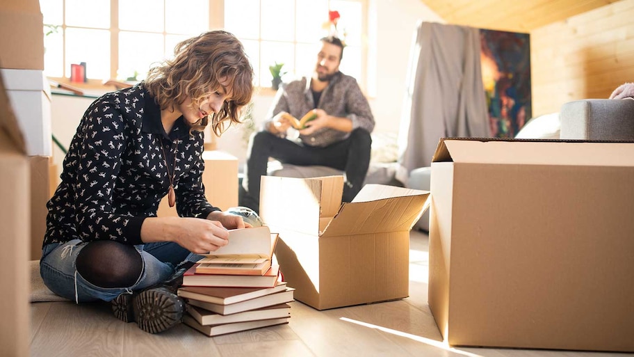 Woman organizing book collection before packing it