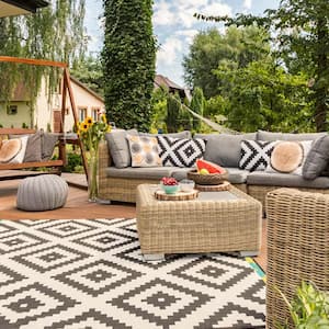 Shot of spacious terrace with cosy garden furniture and a carpet with mosaic theme